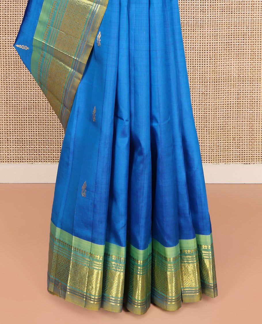 Blue Kanchipuram Silk Saree, Spotlighted with Zari Buttas on Its Body, Complemented by Contrast One-Sided Border of Panner Sombu, Banaras, Muthu, and Jaal Designs, Pallu Features Zari Designs, and Comes Without a Blouse