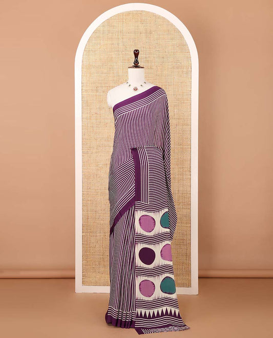 Purple vertical stripes printed modal satin saree, a self-border of horizontal stripes print, polka dots printed on the pallu, and an intricate ajrakh-style printed blouse