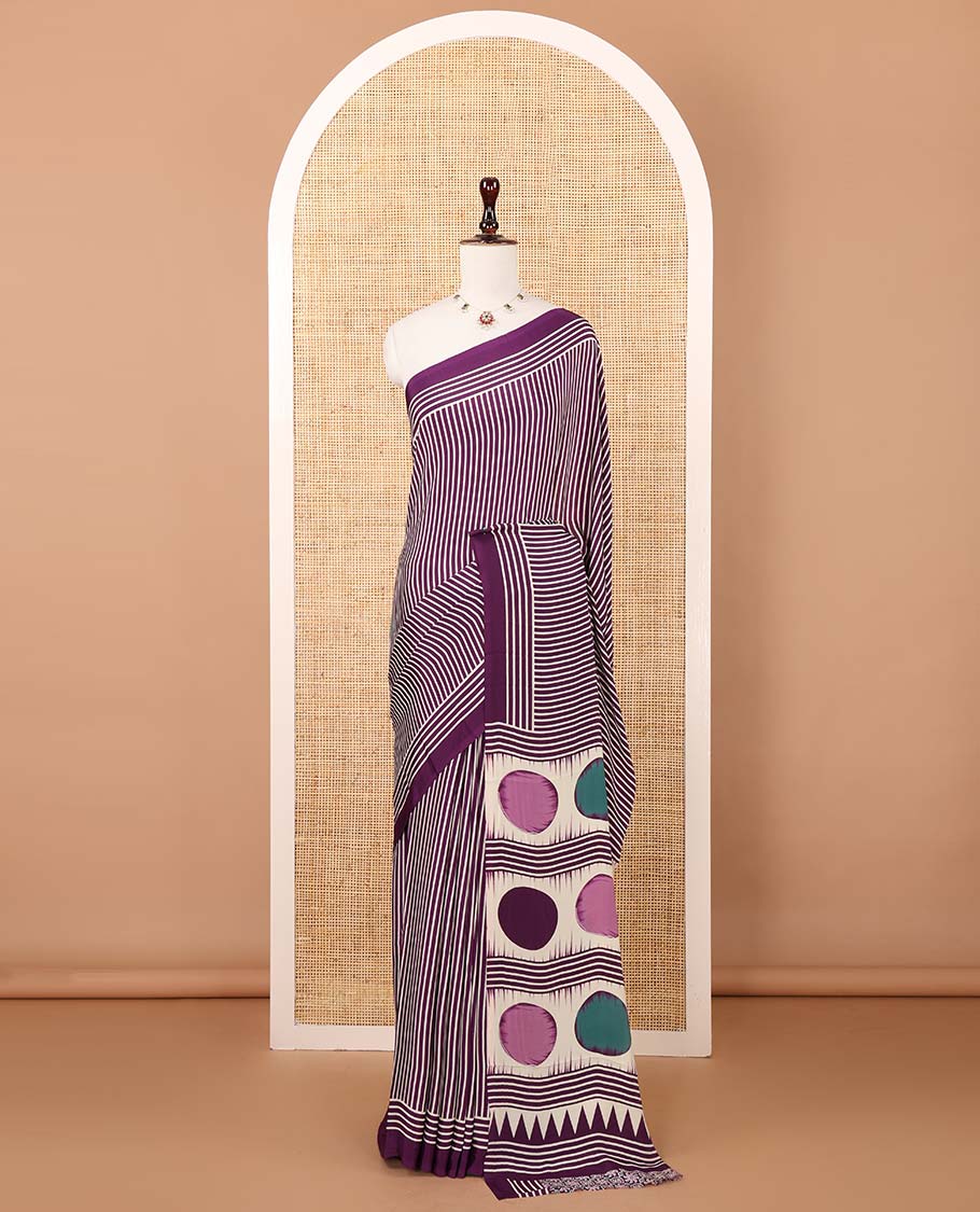Purple vertical stripes printed modal satin saree, a self-border of horizontal stripes print, polka dots printed on the pallu, and an intricate ajrakh-style printed blouse