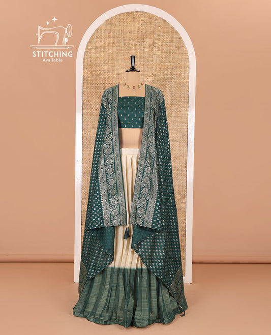 Cream-green Vichitra half-saree, plain and contrast bordered skirt, contrast leaf buttas blouse, dhavani of buttas and floral creeper designs