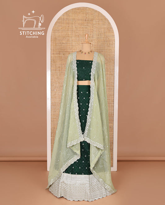 Green half-saree, floral motifs embroidered semi-raw silk top, matching embroidered blouse, and contrast scallop embroidered georgette dhavani