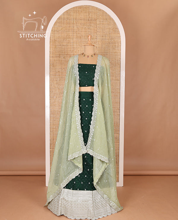 Green half-saree, floral motifs embroidered semi raw silk top, matching embroidered blouse, and contrast scallop embroidered georgette dhavani