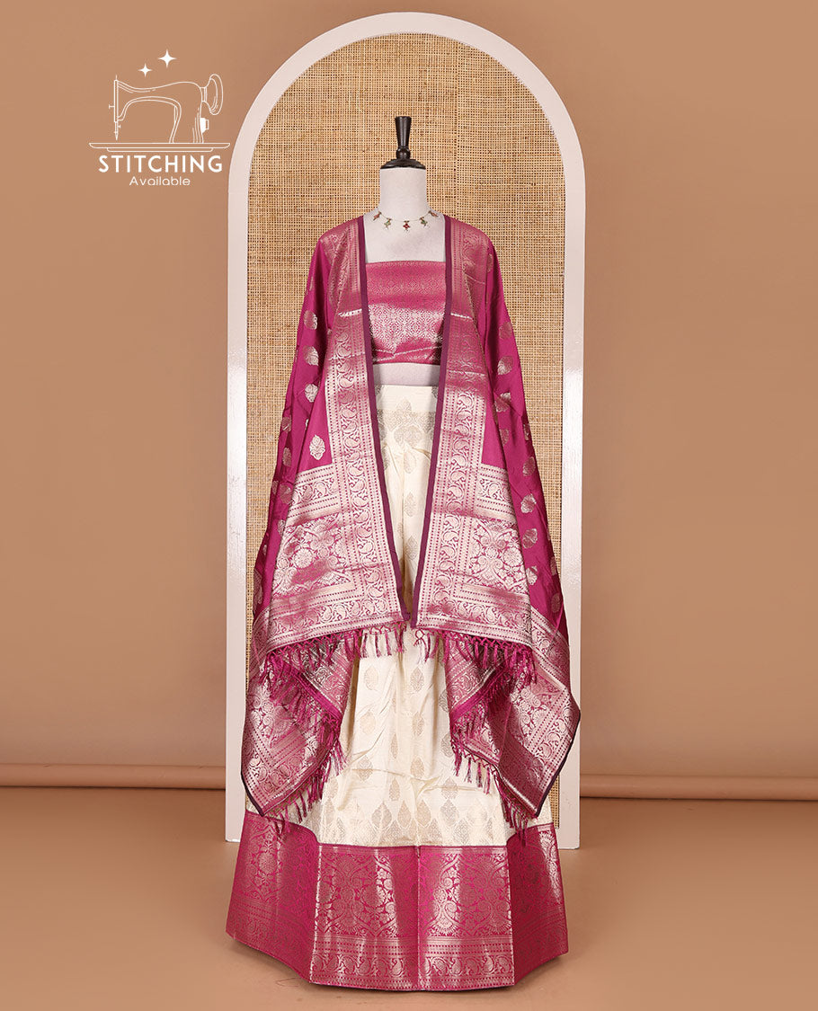 Cream with magenta semi-banarasi half-saree, zari buttas with contrast traditional zari border skirt, zari jacquard blouse, and zari design dhavani