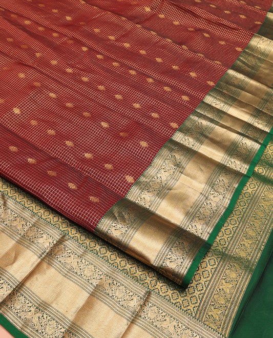 Brown Vasundhara Lite Silk Mix Saree, Meticulously Crafted with Zari Buttas and Checks On Its Body, Complemented by Contrast Border of Thilakam Mokku, Muthu, Banaras, Mayil, and Mayil Kann Designs, Grandly Decked Up Pallu and Paired with a Contrast Blouse