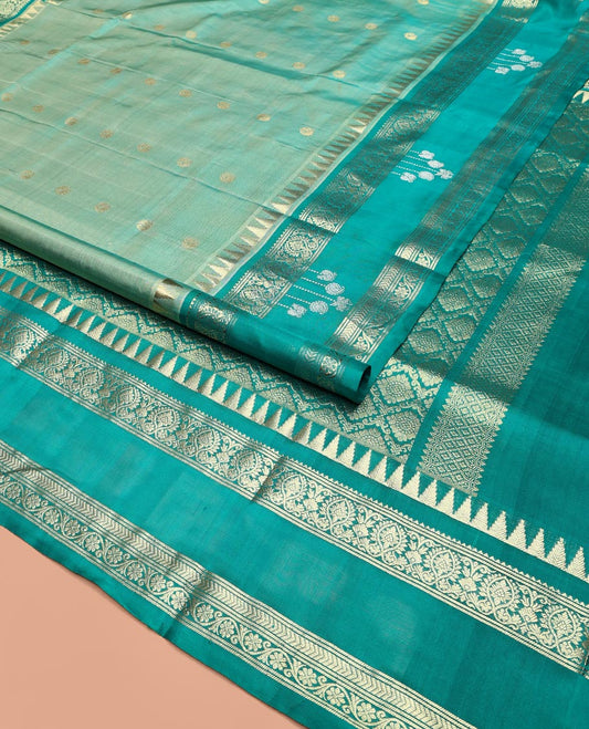 Blue Venkatagiri Silk Saree, Mesmerized with Zari Buttas All Over Its Body, Complemented by a Contrast Temple Traditional Zari Designs Border, Grand Pallu of Jaal Designs, and Paired with a Contrast Blouse