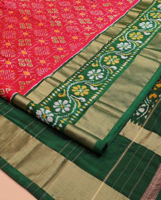 Red Ikkat Silk Saree, Ornamented with Ikkat Buttas Enclosed Checks All Over Its Body, Complemented by a Contrast Border of Floral Creeper Ikkat and Diamond Zari Designs, Pallu of Floral Creeper Designs, and Paired with a Matching Blouse