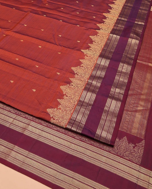 Rust Orange Vasundhara Silk Saree, Enriched with Zari Buttas All Over Its Body, Complemented by a Contrast Rettai Pettu Border of Ara Bogudi, Banaras, Muthu, and Ara Maadam Designs, Grand Jaal Pallu, and Paired with a Contrast Blouse