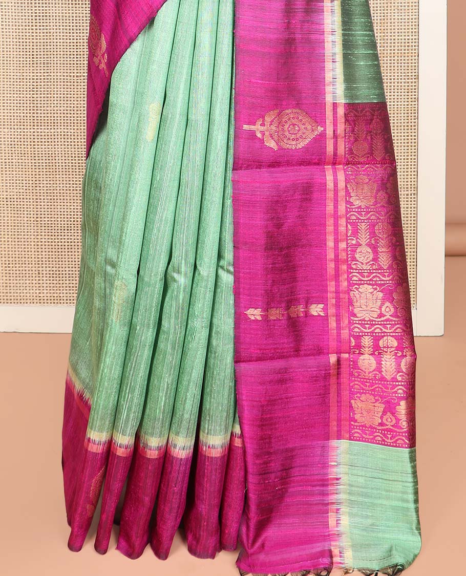 Green Dupion Silk Saree, Charmingly Accented with Buttas on Its Body, Complemented by a Contrast Border of Floral-Style Motifs, Intricately Designed Pallu, and Paired with a Contrast Blouse