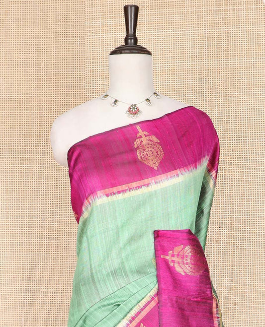 Green Dupion Silk Saree, Charmingly Accented with Buttas on Its Body, Complemented by a Contrast Border of Floral-Style Motifs, Intricately Designed Pallu, and Paired with a Contrast Blouse