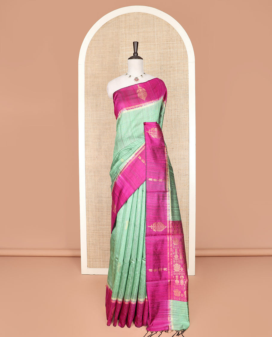 Green Dupion Silk Saree, Charmingly Accented with Buttas on Its Body, Complemented by a Contrast Border of Floral-Style Motifs, Intricately Designed Pallu, and Paired with a Contrast Blouse