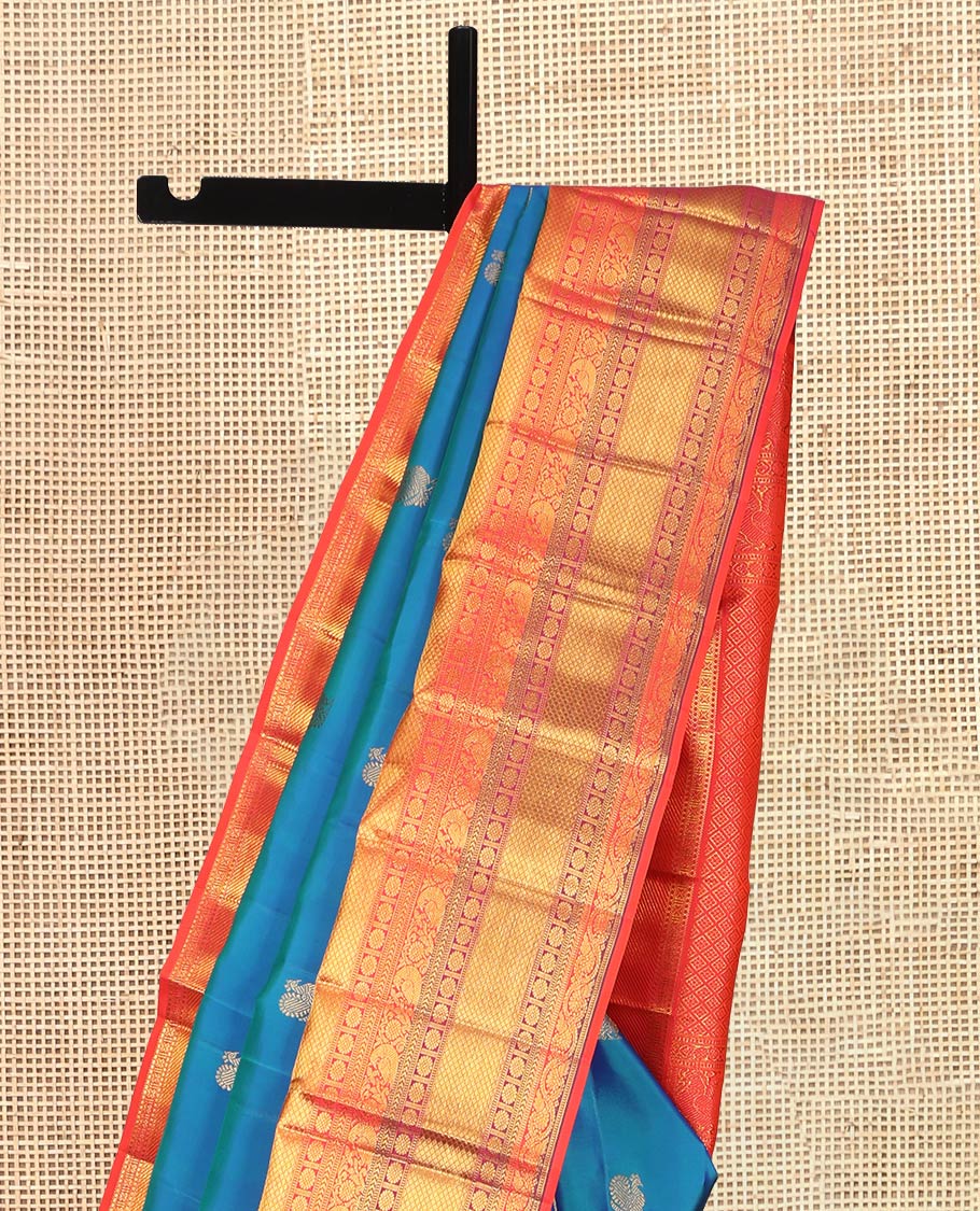 Blue Kanchipuram Silk Saree, Accentuated with Mayil Buttas, a Contrast Korvai Border of Thilakam Mokku, Yaali, Kamalam, Kuyil Kann, Mayil, and Dhavana Kodi, Jaal Pallu, and a Contrast Blouse