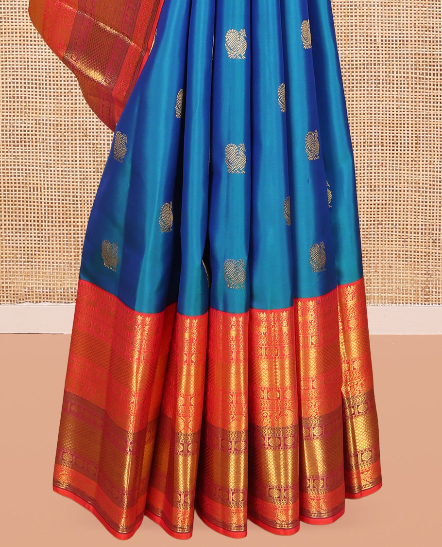 Blue Kanchipuram Silk Saree, Accentuated with Mayil Buttas, a Contrast Korvai Border of Thilakam Mokku, Yaali, Kamalam, Kuyil Kann, Mayil, and Dhavana Kodi, Jaal Pallu, and a Contrast Blouse