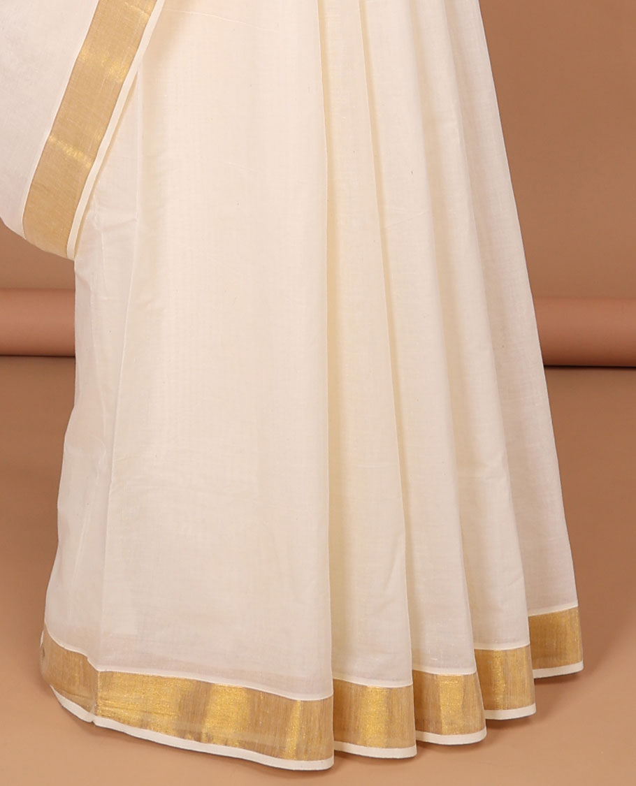 Cream kerala saree with zari stripes, zari border & pallu of floral designs in zari