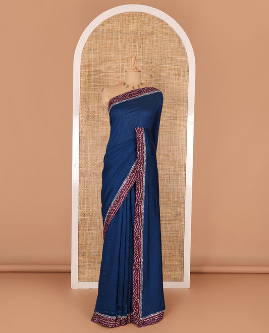 Blue plain Vichitra silk saree, contrast bandhani printed with Swarovski micro-stonework border, and a contrast bandhani printed blouse
