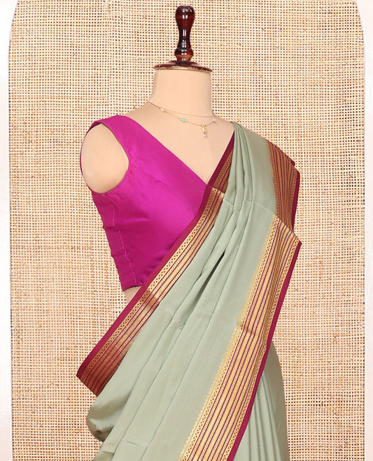 Green Plain Mysore Silk Saree Complemented by Captivating Contrast Traditional Zari Designs Woven Border, Gleaming Zari Striped Pallu and Paired with a Contrast Blouse