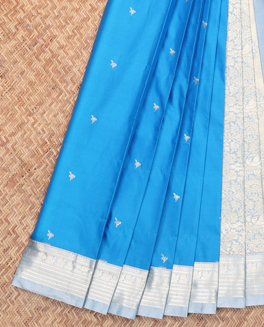 Blue Budget Silk Saree, Embellished with Zari Buttas All Over Its Body, Complemented by a Contrast Traditional Zari Design Border, Mughal-Style Floral Designs Pallu, and Paired with a Contrast Blouse