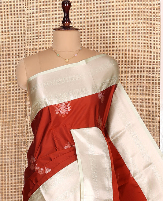 Rust Orange Budget Silk Saree, Ornamented with Zari Buttas All Over Its Body, Complemented by a Contrast Border of Traditional Zari Designs, Intricately Designed Pallu, and Paired with a Contrast Blouse