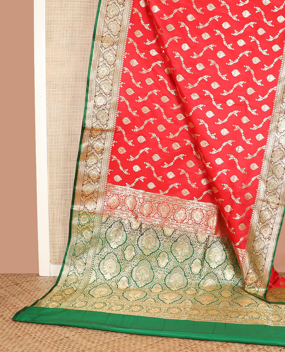 Red zari buttas and leaf vine banarasi silk saree, contrast floral creeper design border, and intricately patterned pallu