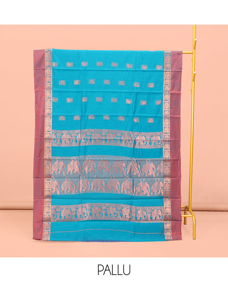 Blue Semi-Silk Cotton Saree, Decked Up with Zari Buttas All Over Its Body, Complemented by a Contrast Kal Eragina Border of Peacock Designs, Pallu Steeped with Elephant Zari Motifs, and Paired with a Matching Blouse