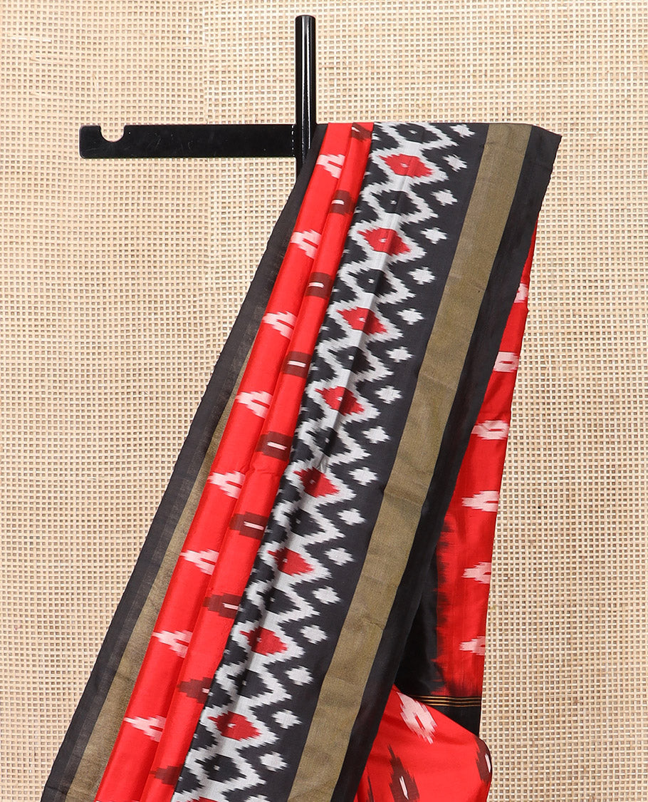 Red Ikkat Silk Saree Brightened with Ikkat Buttas, Complemented by a Contrast Ikkat Design Border, a Hazily Woven Pallu of Diamond Patterns, and a Contrast Blouse