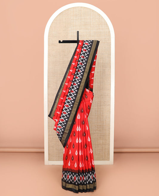 Red Ikkat Silk Saree Brightened with Ikkat Buttas, Complemented by a Contrast Ikkat Design Border, a Hazily Woven Pallu of Diamond Patterns, and a Contrast Blouse