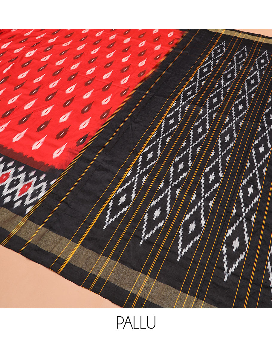 Red Ikkat Silk Saree Brightened with Ikkat Buttas, Complemented by a Contrast Ikkat Design Border, a Hazily Woven Pallu of Diamond Patterns, and a Contrast Blouse
