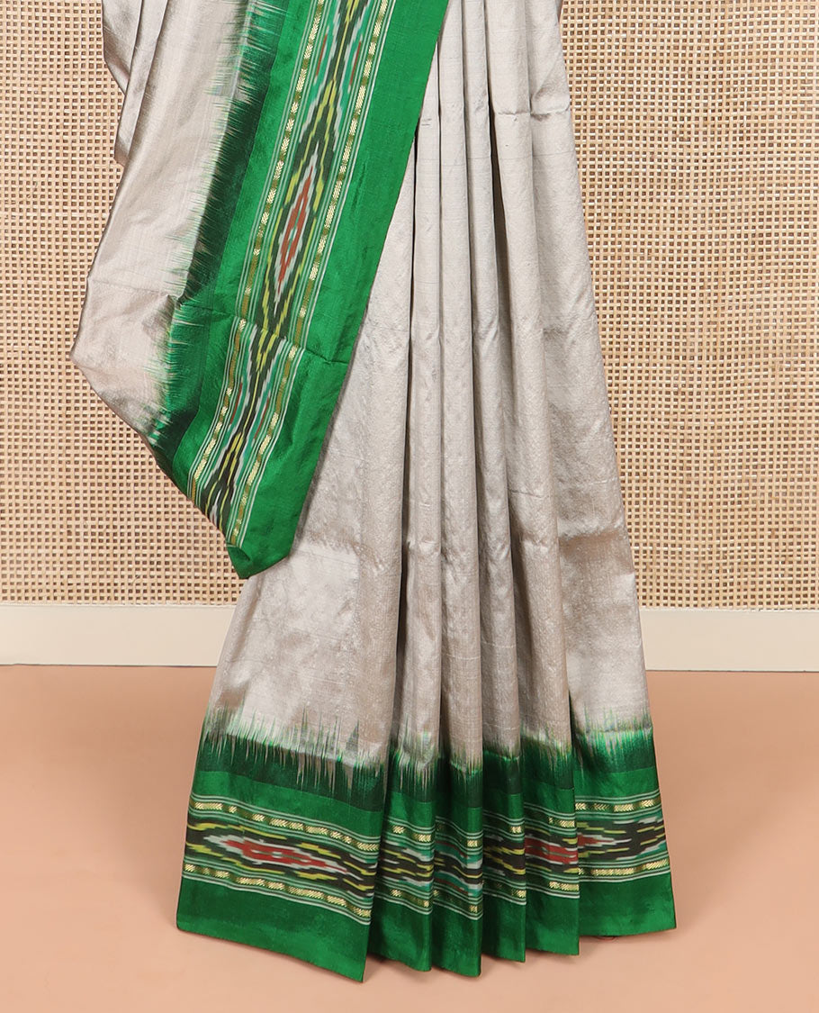 Grey Plain Ikkat Silk Saree with a Contrast Green Border Decked with a Hazy Ikkat Weave, Featuring a Pallu Flanked by Stripes and Ikkat Texture