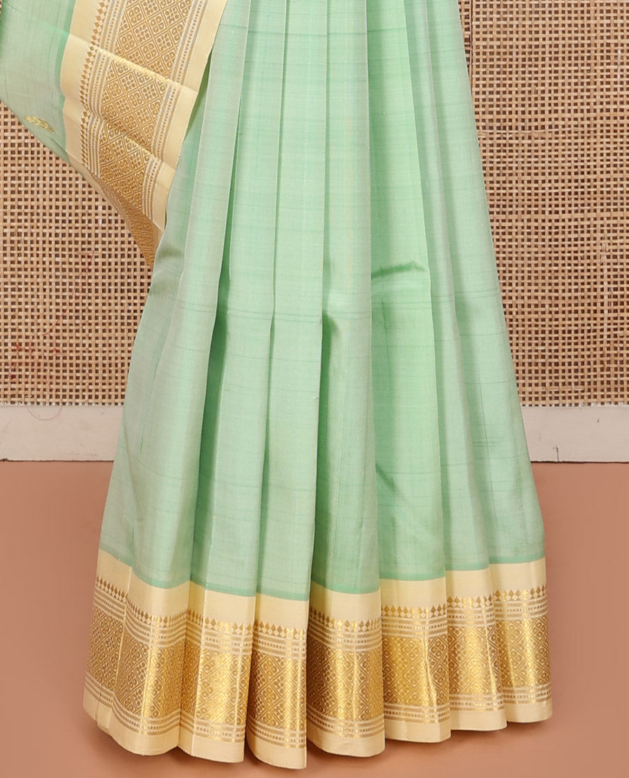 Green Kanchipuram Silk Saree, Featuring Zari Buttas, a Contrast One-Sided Border of Panner Sombu, Muthu, Banaras, and Jaal Design, Zari Design Pallu, and No Blouse