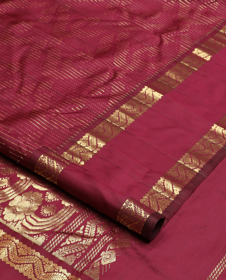 Maroon zari buttas Kanchipuram silk saree, one-sided rettai pettu zari border, and intricately designed pallu