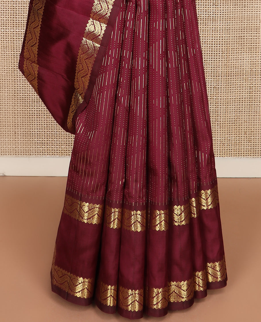 Maroon zari buttas Kanchipuram silk saree, one-sided rettai pettu zari border, and intricately designed pallu