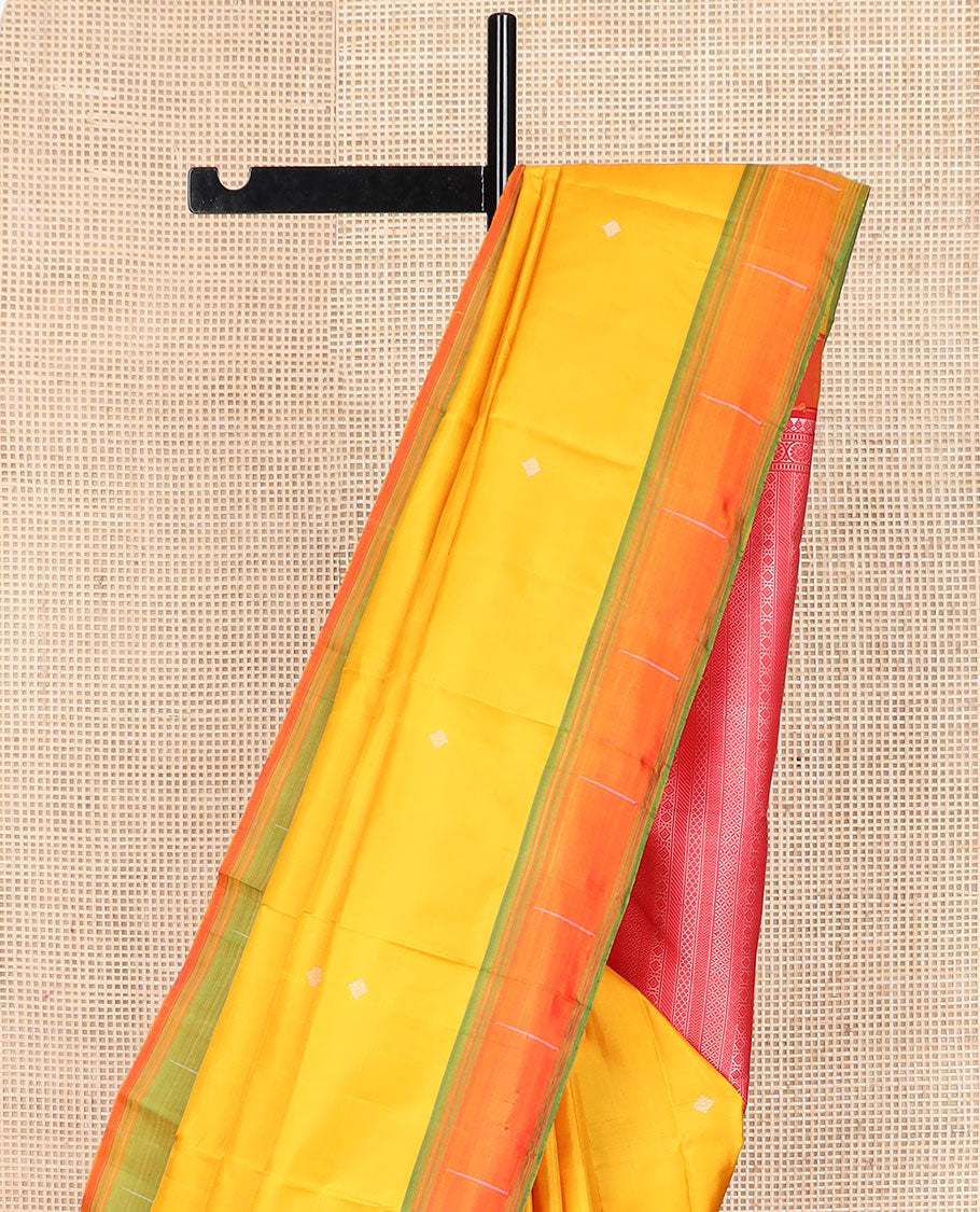 Yellow buttas Kanchipuram silk saree, contrast border of malli mokku designs, and pallu of geometric designs