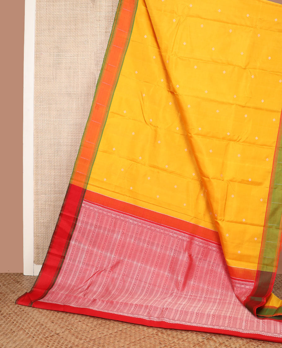 Yellow buttas Kanchipuram silk saree, contrast border of malli mokku designs, and pallu of geometric designs
