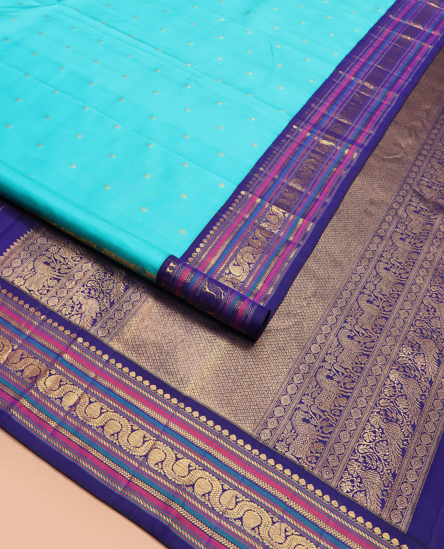Blue zari buttas Kanchipuram silk saree, contrast border of thilakam mokku, banaras, kathir, and dhavana manga designs, and mayil kann design pallu