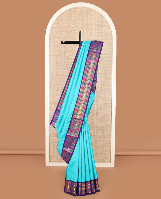 Blue zari buttas Kanchipuram silk saree, contrast border of thilakam mokku, banaras, kathir, and dhavana manga designs, and mayil kann design pallu