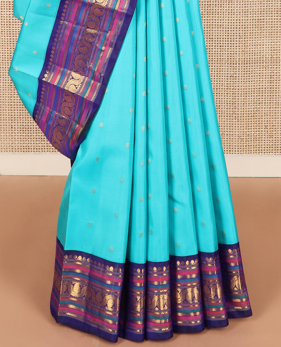 Blue zari buttas Kanchipuram silk saree, contrast border of thilakam mokku, banaras, kathir, and dhavana manga designs, and mayil kann design pallu
