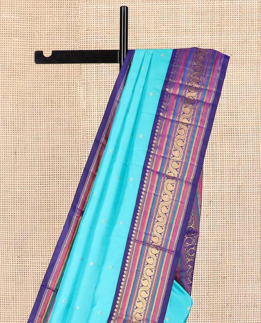 Blue zari buttas Kanchipuram silk saree, contrast border of thilakam mokku, banaras, kathir, and dhavana manga designs, and mayil kann design pallu