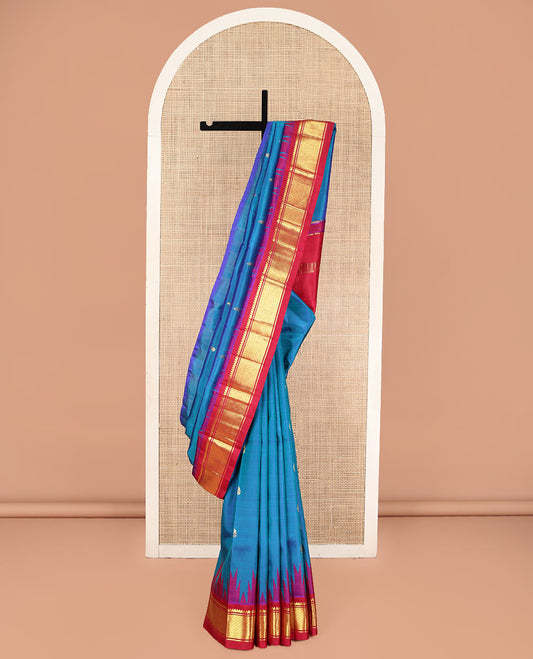 Blue Kanchipuram Silk Saree, Beautifully Bedecked with Zari Buttas, Complemented by Contrast One-Sided Border of Thazampoo Rekku, Thilakam Mokku, and Jaal Designs, Pallu of Zari Designs, and Comes Without a Blouse