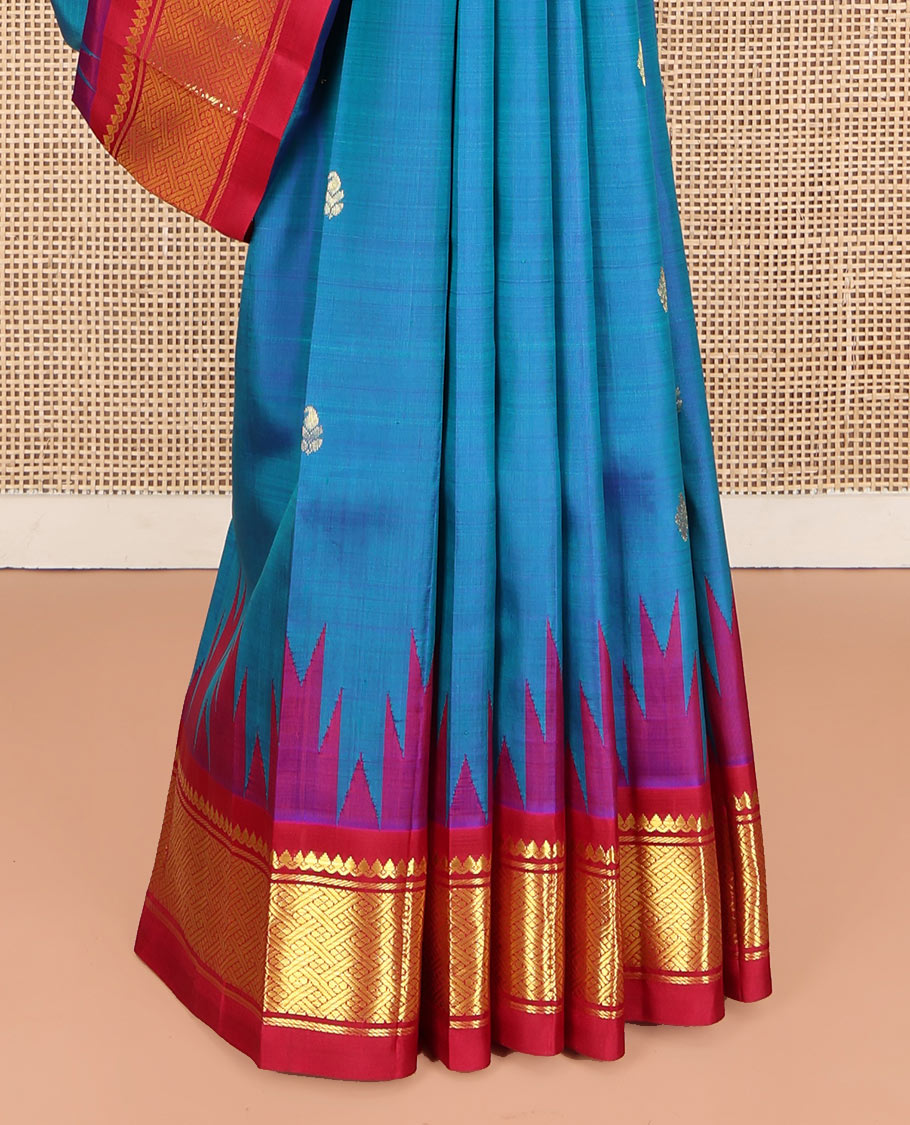 Blue Kanchipuram Silk Saree, Beautifully Bedecked with Zari Buttas, Complemented by Contrast One-Sided Border of Thazampoo Rekku, Thilakam Mokku, and Jaal Designs, Pallu of Zari Designs, and Comes Without a Blouse