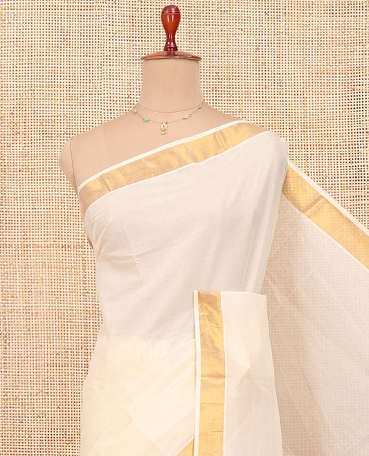 Cream Kerala Cotton Saree, Woven with Zari Buttas All Over Its Body, a Zari Bavanji Border, Pallu of Zari Designs, and Paired with a Matching Blouse