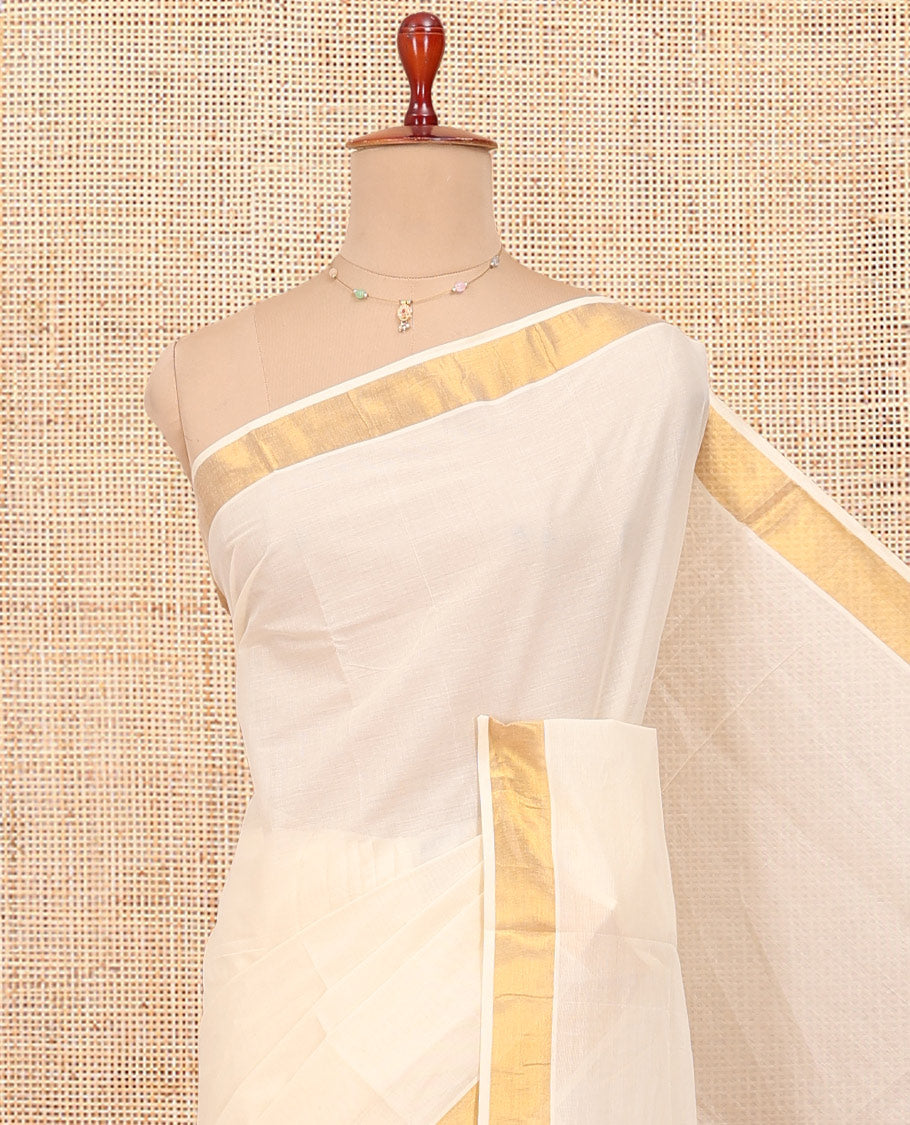 Cream Kerala Cotton Saree, Woven with Zari Buttas All Over Its Body, a Zari Bavanji Border, Pallu of Zari Designs, and Paired with a Matching Blouse