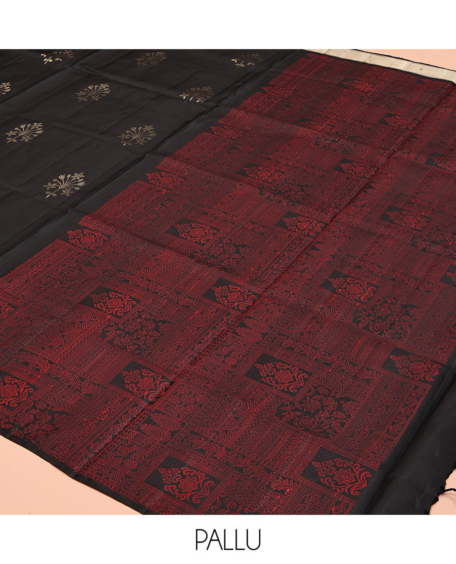Black Mayuri Soft Silk Saree, Adorned with Zari Buttas, a Self-Border, and a Pallu Features an Intricate Thread Weave, and a Matching Blouse