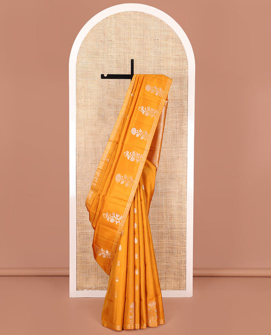 Orange Mayuri Soft Silk Saree, Elegantly Woven with Floral Zari Buttas on Its Body, Subtle Piping Border, Majestically Detailed Pallu, and Paired with a Matching Blouse
