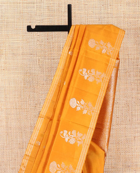 Orange Mayuri Soft Silk Saree, Elegantly Woven with Floral Zari Buttas on Its Body, Subtle Piping Border, Majestically Detailed Pallu, and Paired with a Matching Blouse