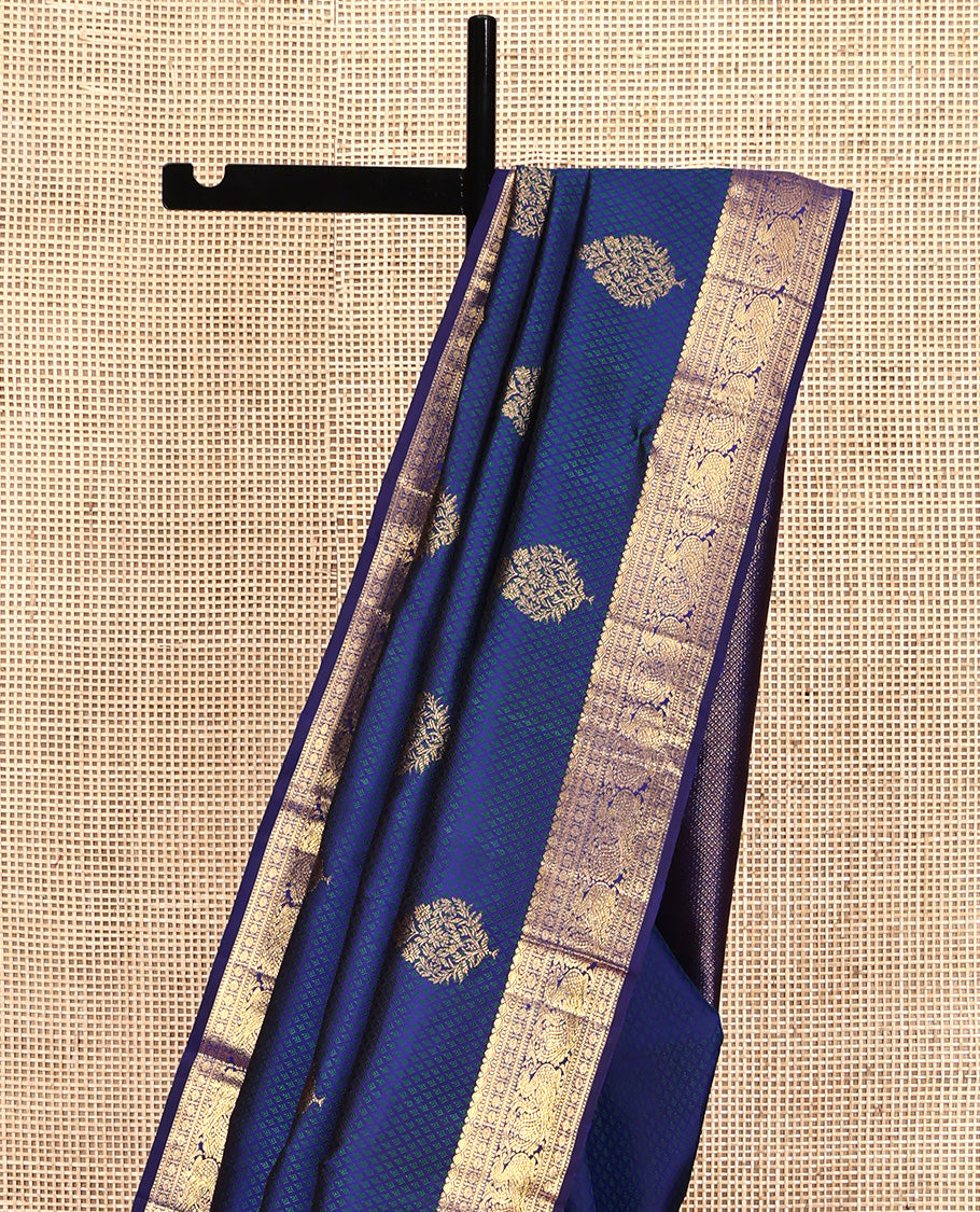 Blue Parampara Silk Saree, Graced with Zari Buttas and Embossed Texture On Its Body Highlighted by Zari Border of Muthu, Poun, and Mayil Designs, Pallu of Ara Maadam Designs, and Paired with a Matching Blouse