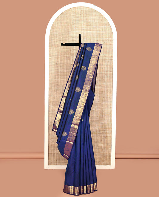 Blue Parampara Silk Saree, Graced with Zari Buttas and Embossed Texture On Its Body Highlighted by Zari Border of Muthu, Poun, and Mayil Designs, Pallu of Ara Maadam Designs, and Paired with a Matching Blouse