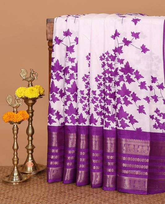White leaf printed dola silksaree,contrast gold zari border of traditional motifs, geometric printed pallu & printed violet blouse