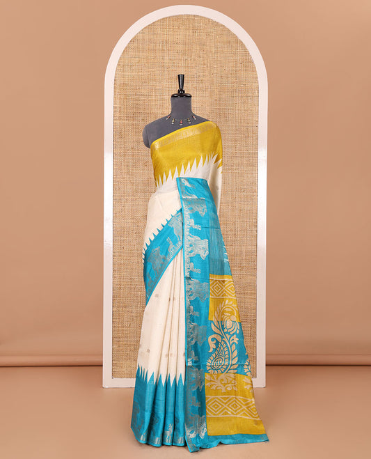 Half-white zari stripes and buttas dola silk saree, contrast yellow-blue Ganga-Jamuna temple elephant motifs border, paisleys printed pallu, and contrast elephant buttas blouse