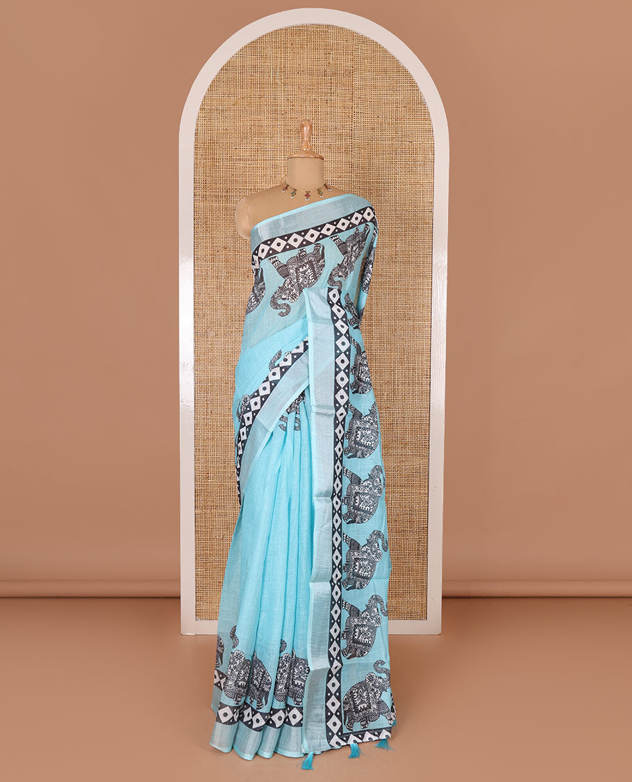 Blue plain linen cotton saree, silver zari border of elephant motifs print, elephant motifs pallu, and a contrast elephant motifs printed blouse