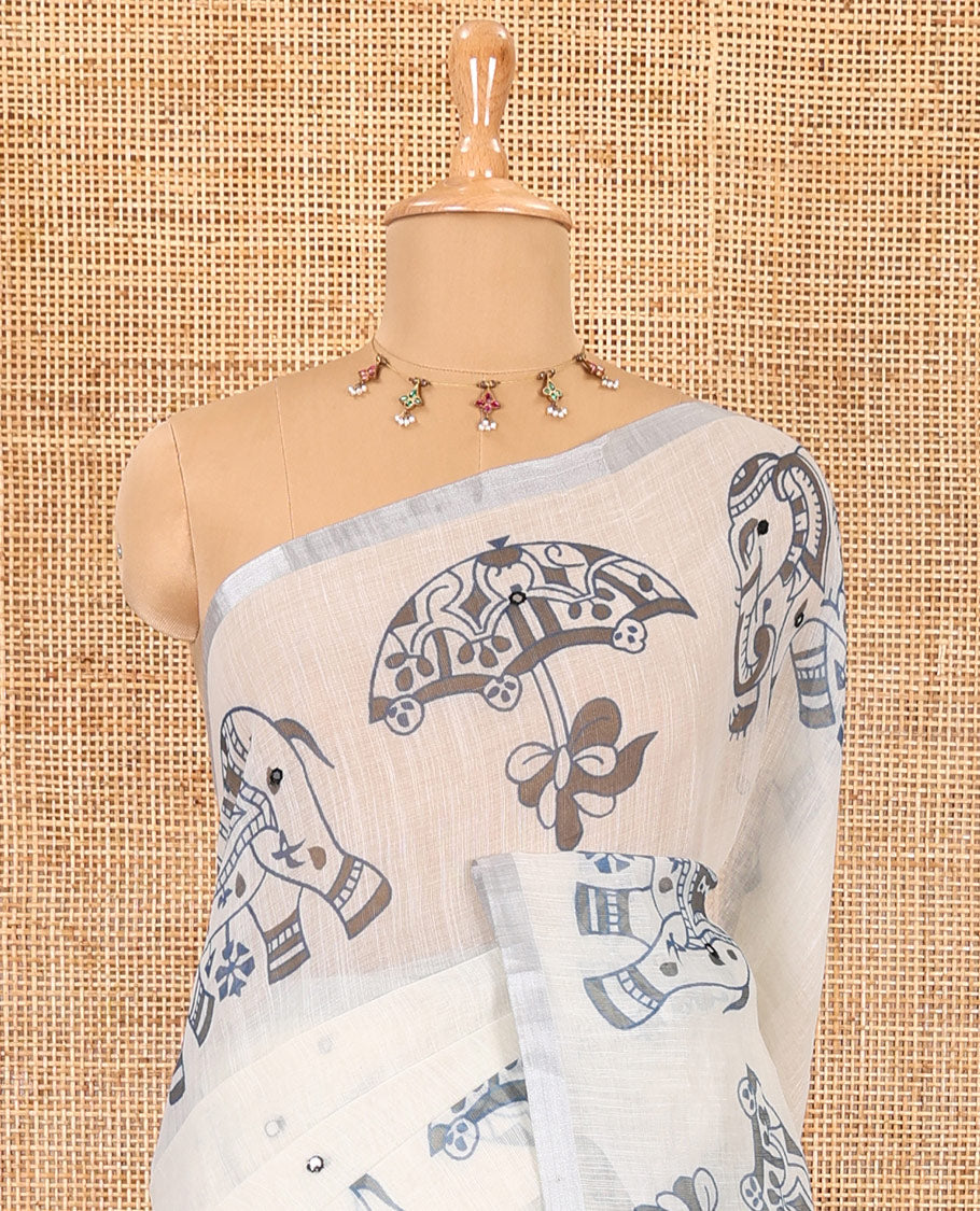 Cream mirror work linen cotton saree, zari border of umbrella and elephant motifs print, pallu of print and mirrorwork, and a contrast printed blouse