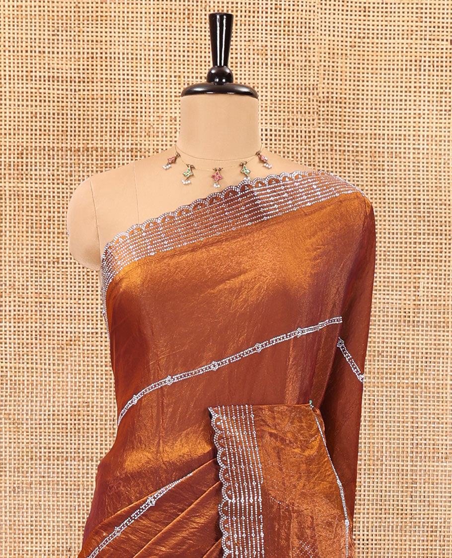 Honey color horizontally swarovski stone striped fendi chiffon saree, swarovski stone work border, and a plain blouse